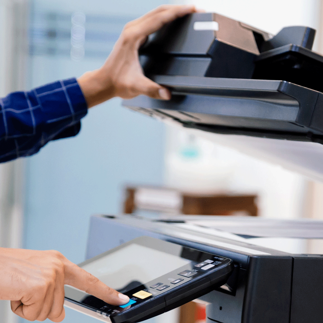 a person using a device to print a photocopier